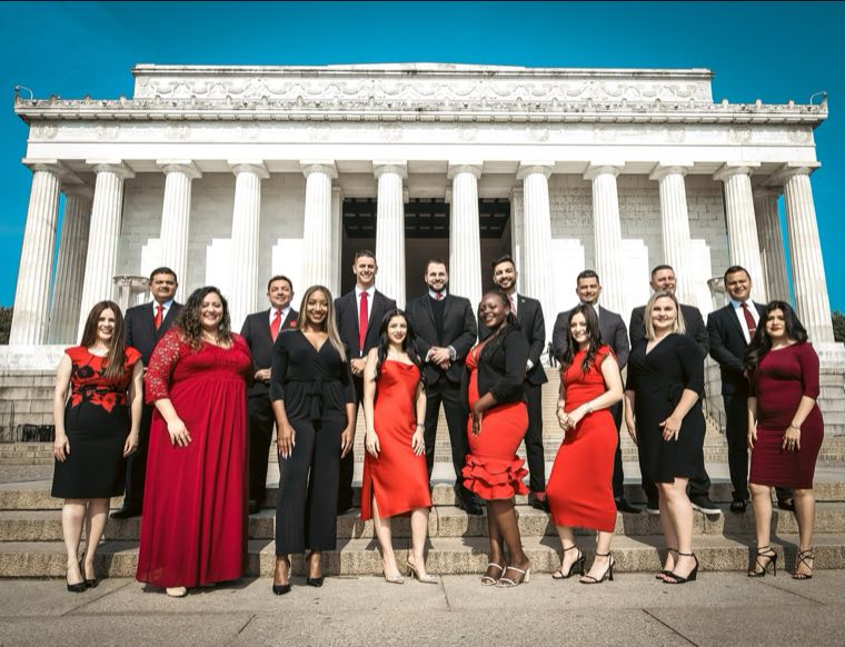 EIB agents in formal attire on the steps of the Lincoln Memorial in Washington, D.C.