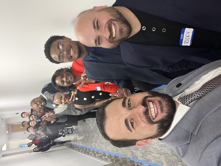 Agents lined up down an office hallway for a group selfie